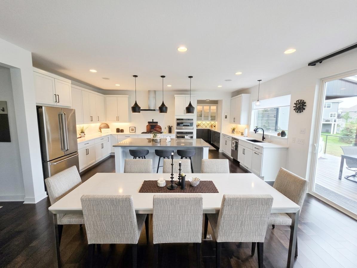 Open kitchen and dining area features an oversized 4' x 8' island and exceptional cabinetry.