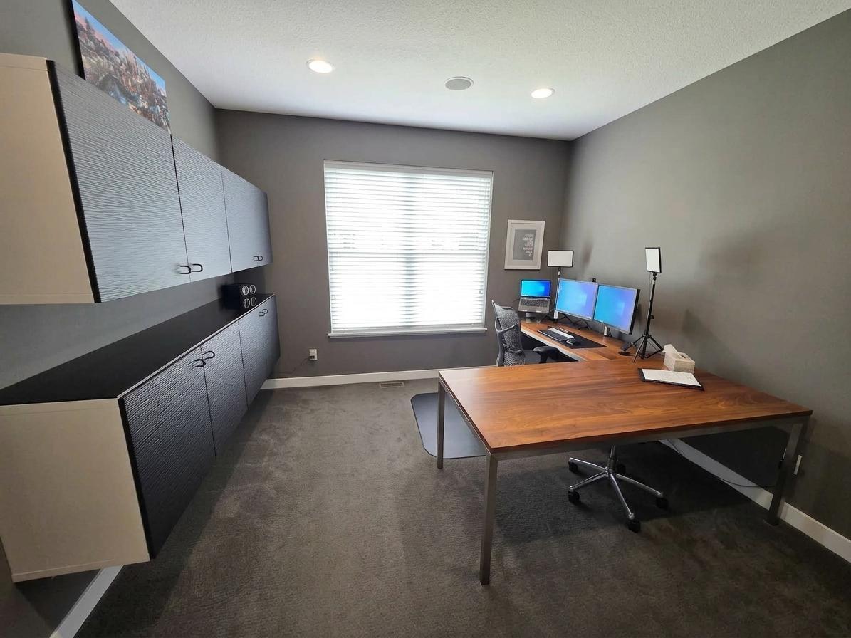 Private main-level office offers generous workspace, extensive cabinetry, hardwired internet and built-in speakers.