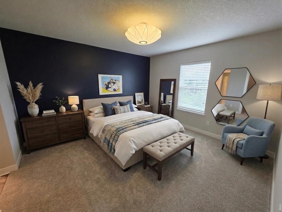 Bright upper-level bedroom with large window, bold accent wall and generous floor space.