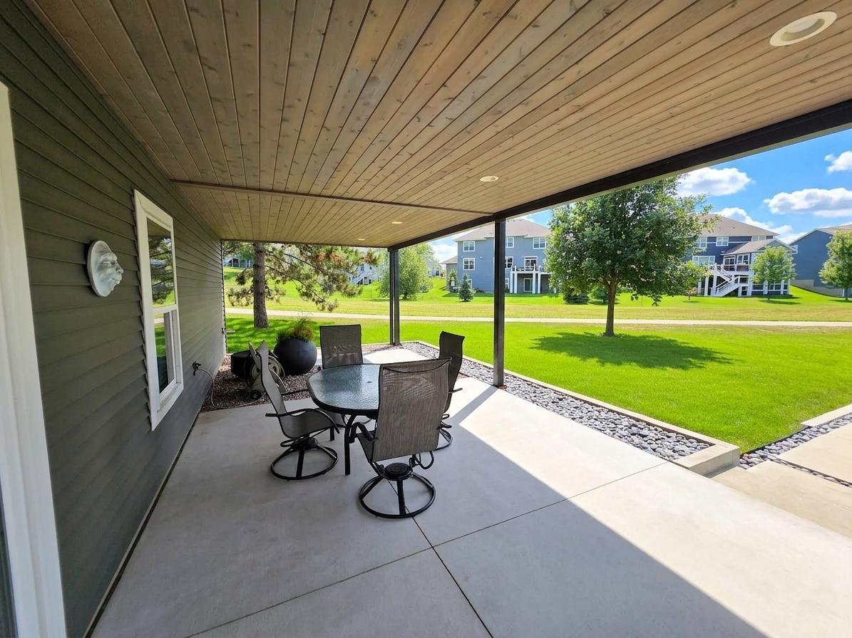 Covered lower patio extends the living space outdoors with recessed lighting and room for dining or conversation seating.
