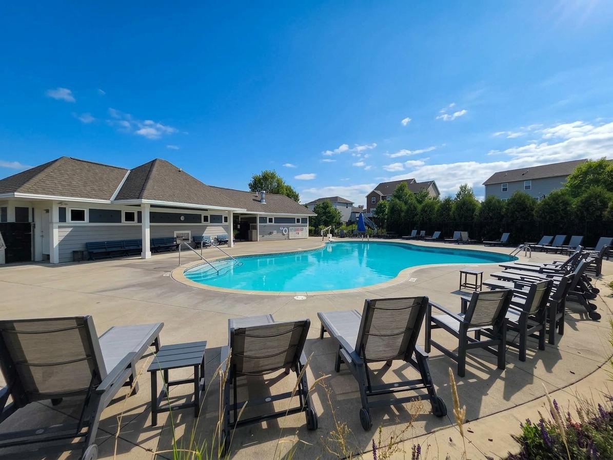 Spacious community pool and surrounding patio offer a convenient neighborhood amenity.