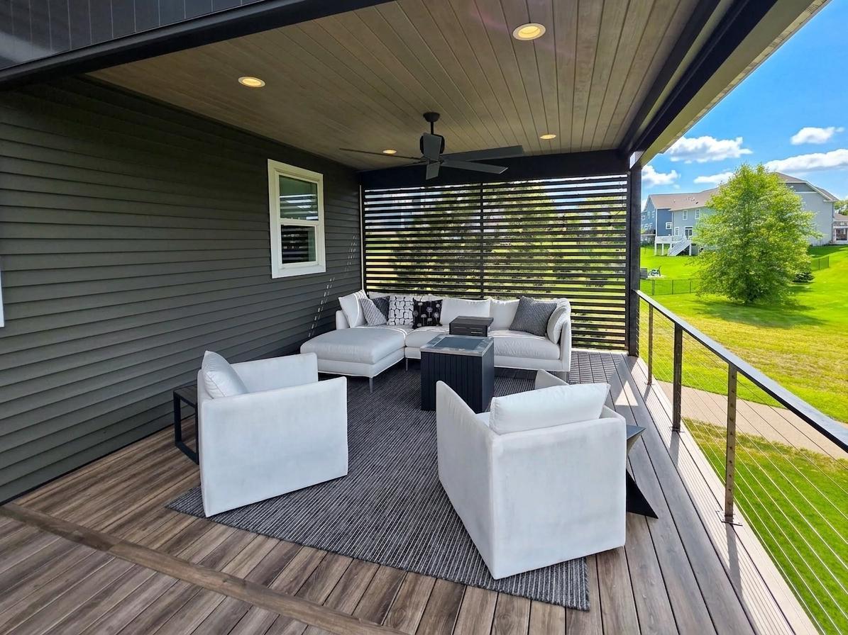 Covered portion of the approximately 14' x 30' deck creates a true outdoor room with ceiling fan, lighting and slatted privacy wall.