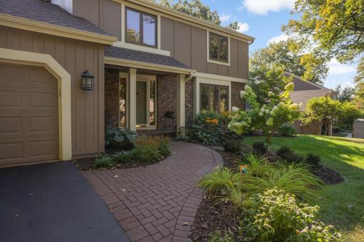 Paver walk surrounded by beautifully maintained landscaping