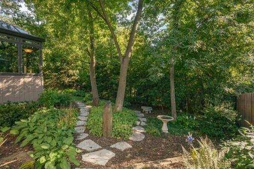 Fully fenced backyard is a zen-like retreat, but you could also transform it into a play area if you prefer. The 6-foot fence keeps deer out.