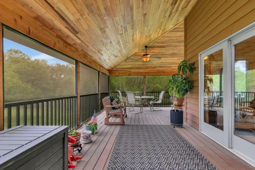 screened in deck overlooks the pond and back yard