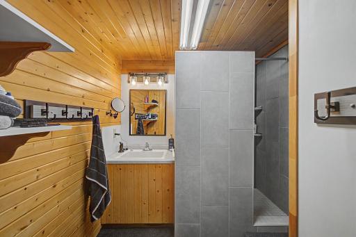 Tiled shower and sink just outside the lower level bathroom