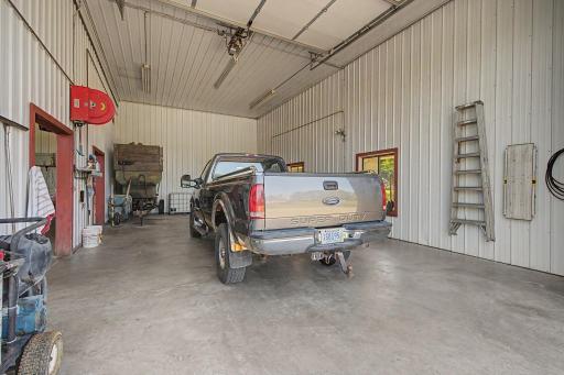 Wash bay with built in pressure washer with steamer stays with home and hose reel. Service door goes to this room as well.
