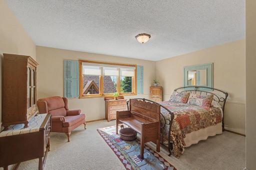 Main floor bedroom with windows over looking the pool and back yard