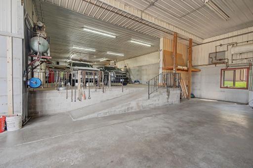 Air compressor and reels stay. Plumping on wall is for hot water heater for both the shop and the half of massive shed only headed by wood stove.