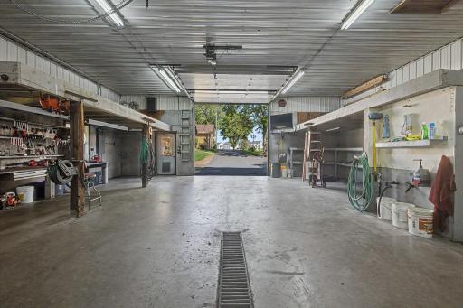Work bench stays with lightening, shop bathroom and floor drains and hot and cold water. This door is 12x11 with openers. Multiple 220v outlets.