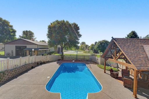 Large patio area fenced in with retaining wall.