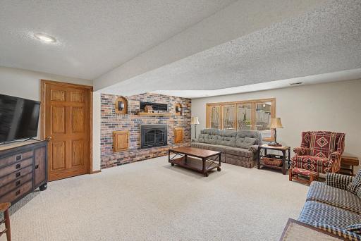 Gas burning fireplace in family room with storage closet. Safe concreted into the wall.