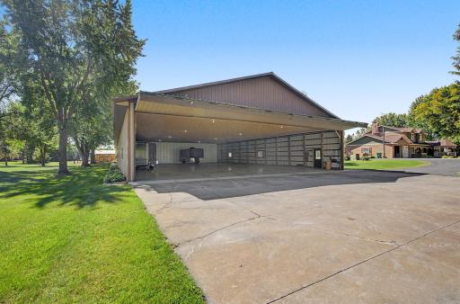 Hanger door open with cement floor, electric lights and no heat in this section 60x120