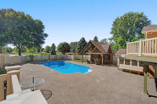 View of pool and pool hut and patio