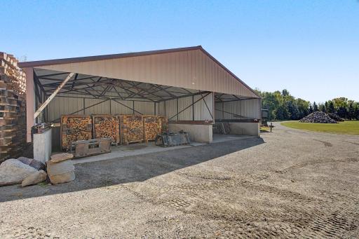 Shed with retractable roof 39x20 and 4 foot cement walls. All pallets and split wood goes with Seller.