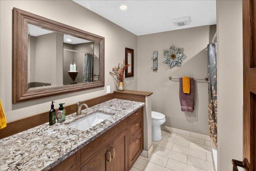 A Stylish Lower-Level Bathroom with Granite Countertops
