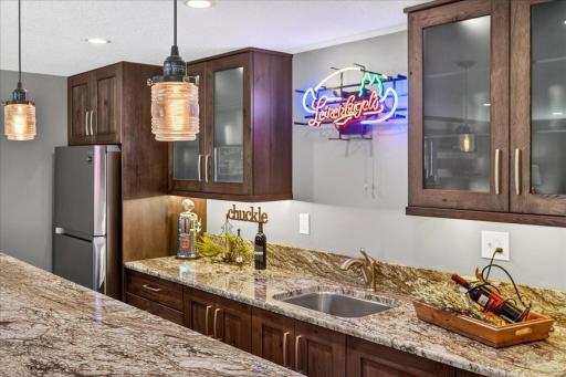 Granite Counters and Rich Cabinetry Elevate the Wet Bar