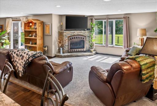Settle In Beside the Lower-Level Stone Fireplace
