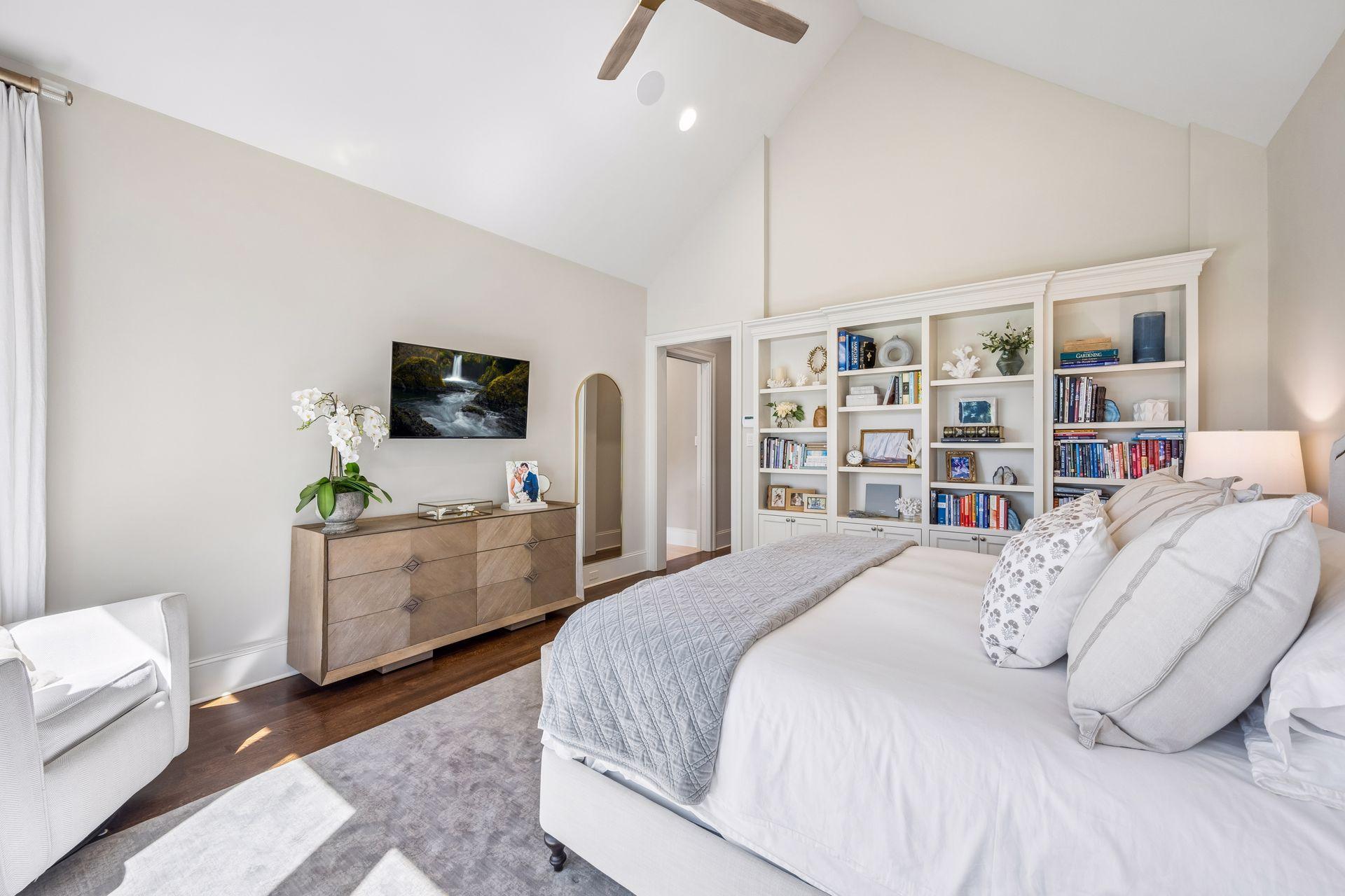 Expansive windows fill the primary suite with natural light.