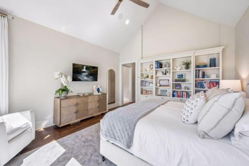 Expansive windows fill the primary suite with natural light.