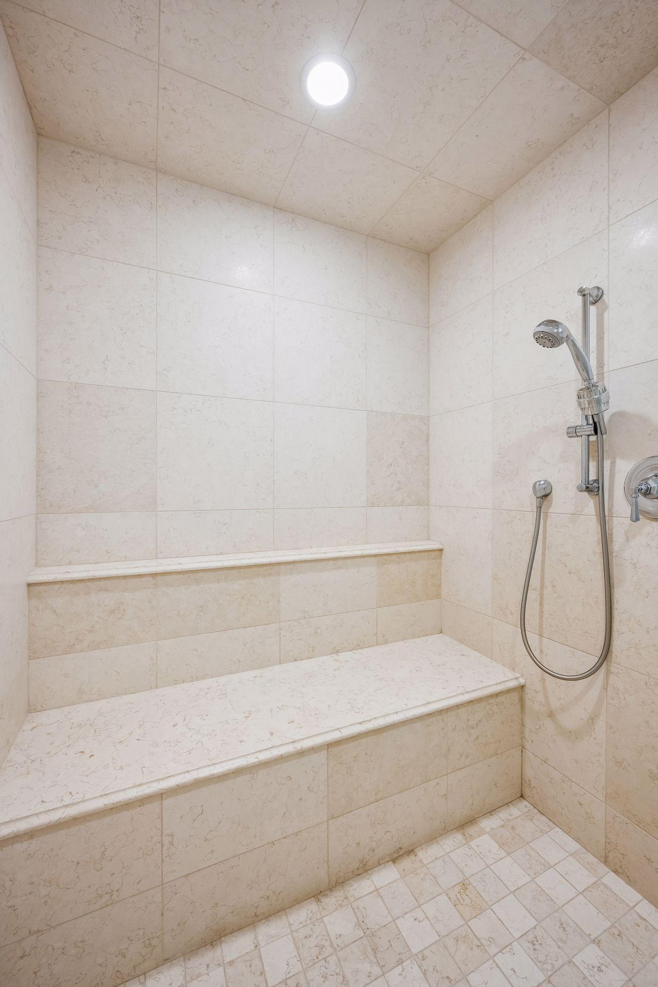 A spacious walk-in shower creates a luxurious centerpiece within the primary bath.
