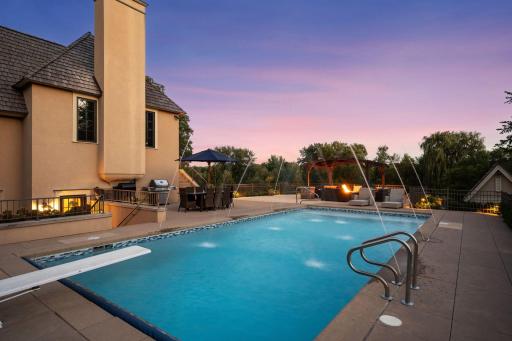 An in-ground pool creates a private resort-like setting overlooking the surrounding grounds.