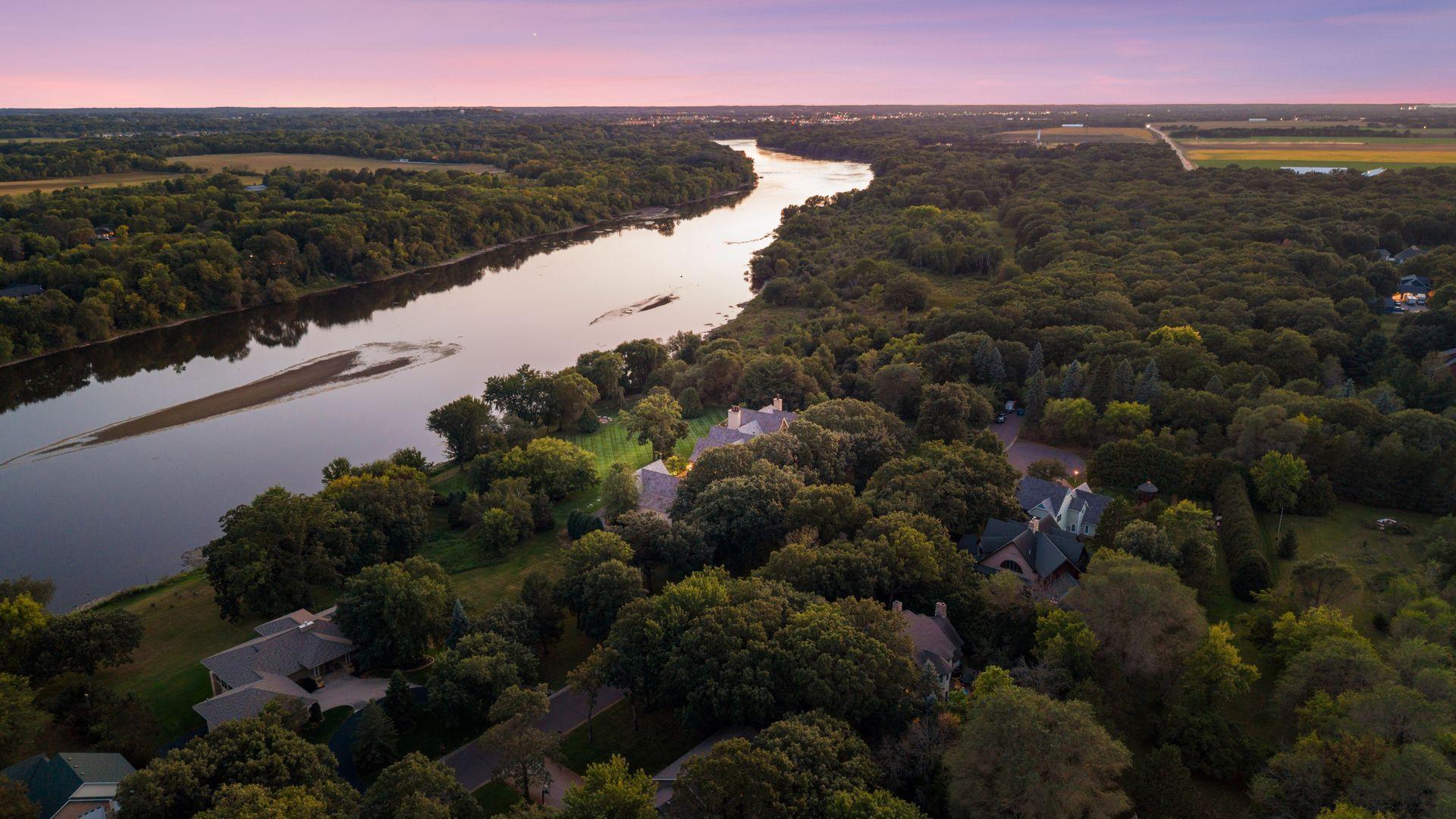 Situated on 3.47 acres with privacy, mature grounds, and remarkable Mississippi River views.