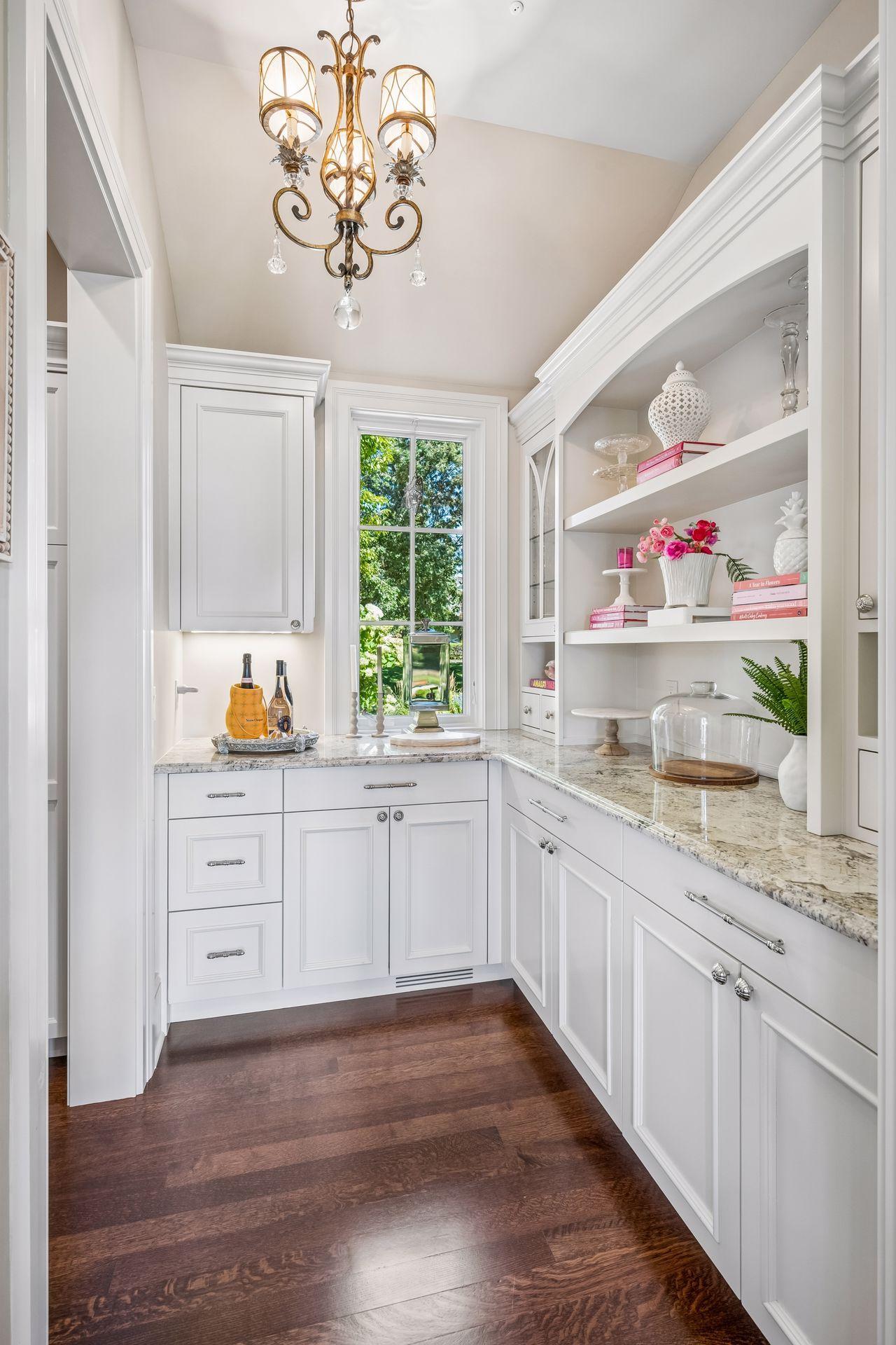 A generous butler’s pantry just beyond the kitchen provides extensive storage and added functionality for entertaining.