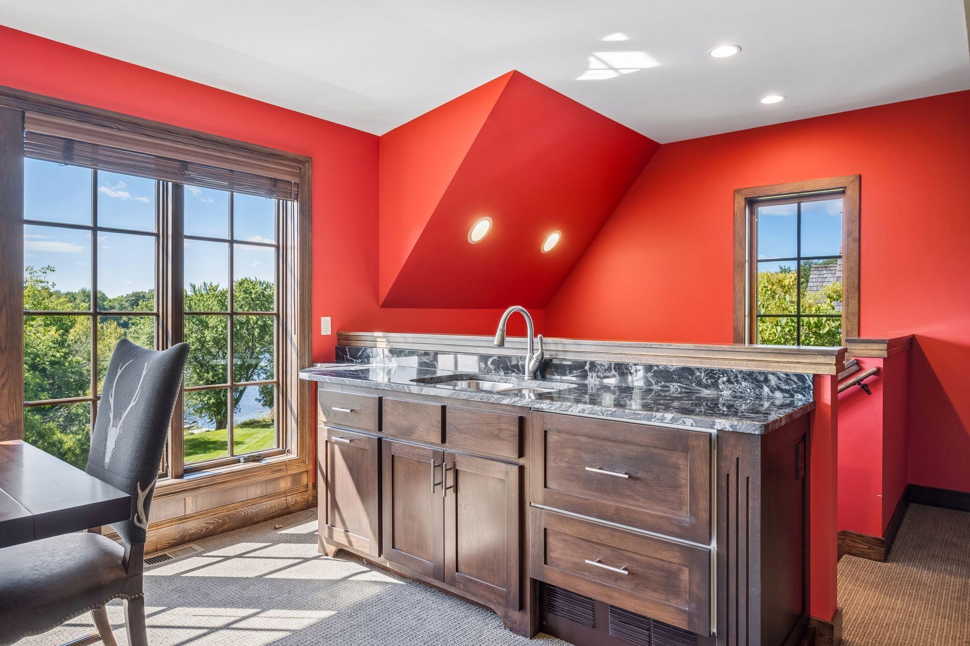 Custom cabinetry, counter space, and a sink enhance the office's versatility.