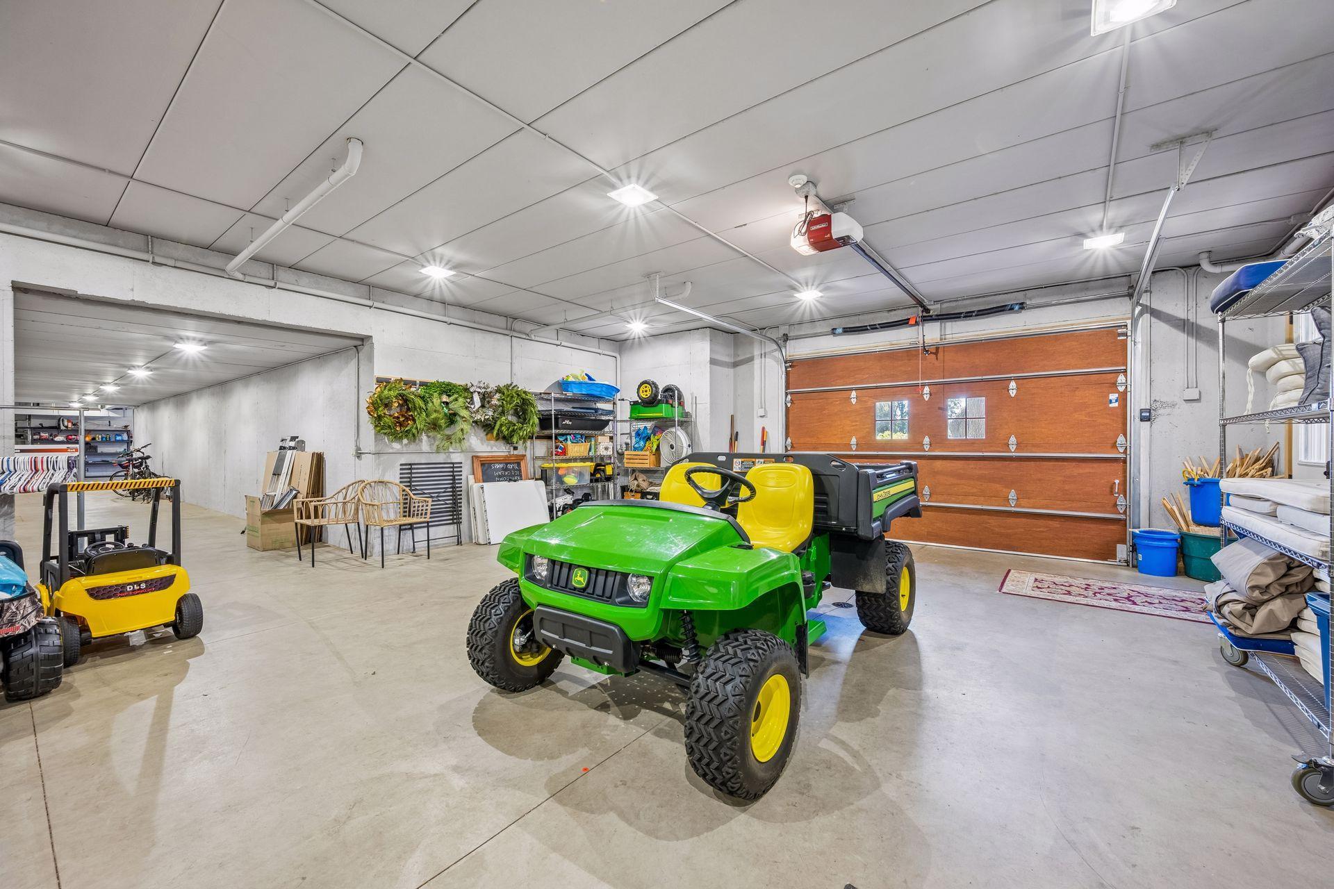 Just beyond this lower garage space, a private concrete tunnel extends beneath the driveway between the residence and detached garage.