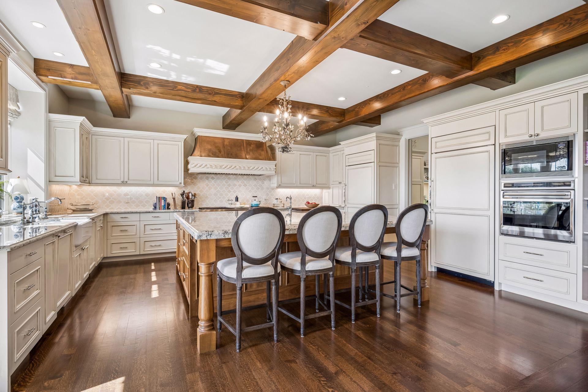 Full-size Sub-Zero refrigeration and integrated appliances are seamlessly concealed behind custom cabinetry, creating a polished, furniture-like aesthetic.
