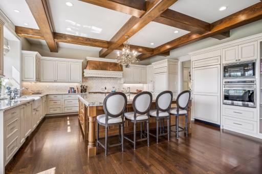 Full-size Sub-Zero refrigeration and integrated appliances are seamlessly concealed behind custom cabinetry, creating a polished, furniture-like aesthetic.