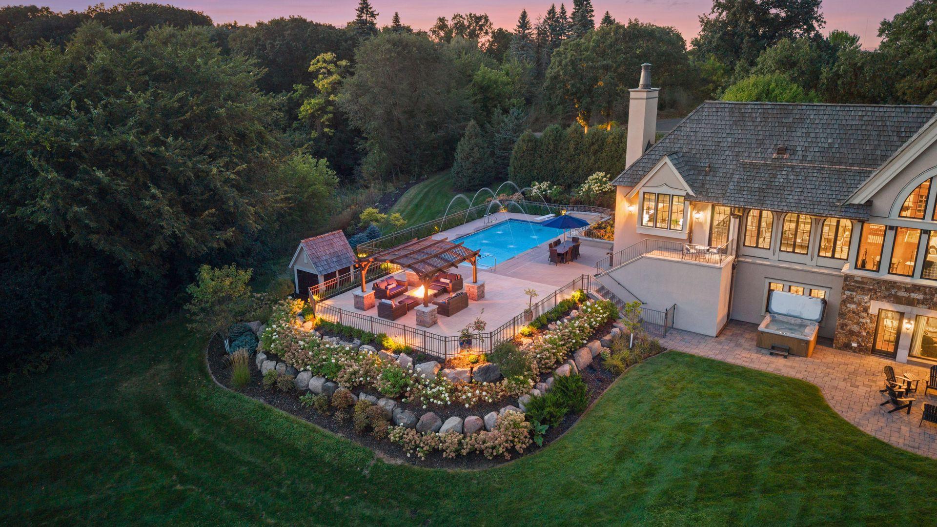 The expansive pool deck offers an exceptional setting for entertaining beneath the summer sun.