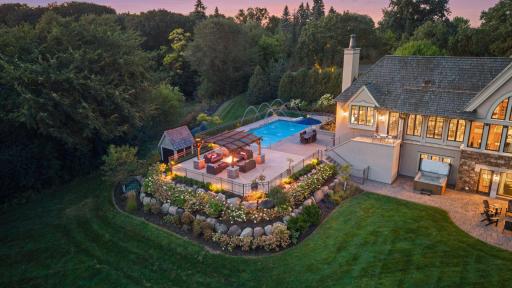 The expansive pool deck offers an exceptional setting for entertaining beneath the summer sun.