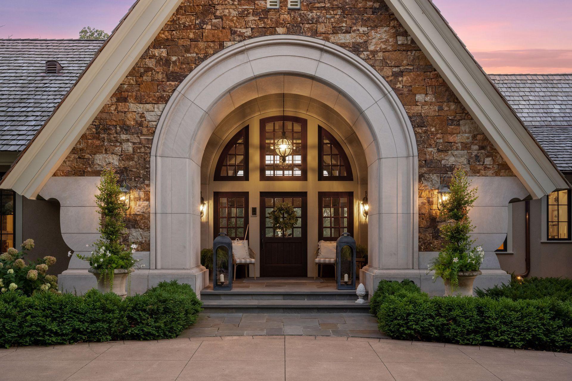 A prominent limestone arched entry creates an unforgettable first impression.