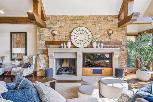 A striking stone fireplace serves as a beautiful focal point in the great room.
