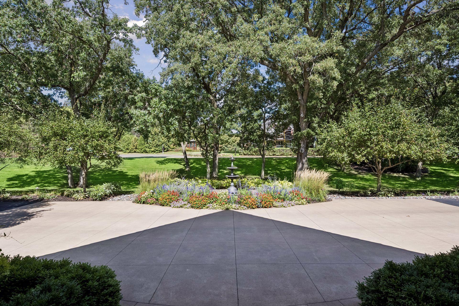 Framed by mature surroundings, the residence takes on a different character as light shifts throughout the day.