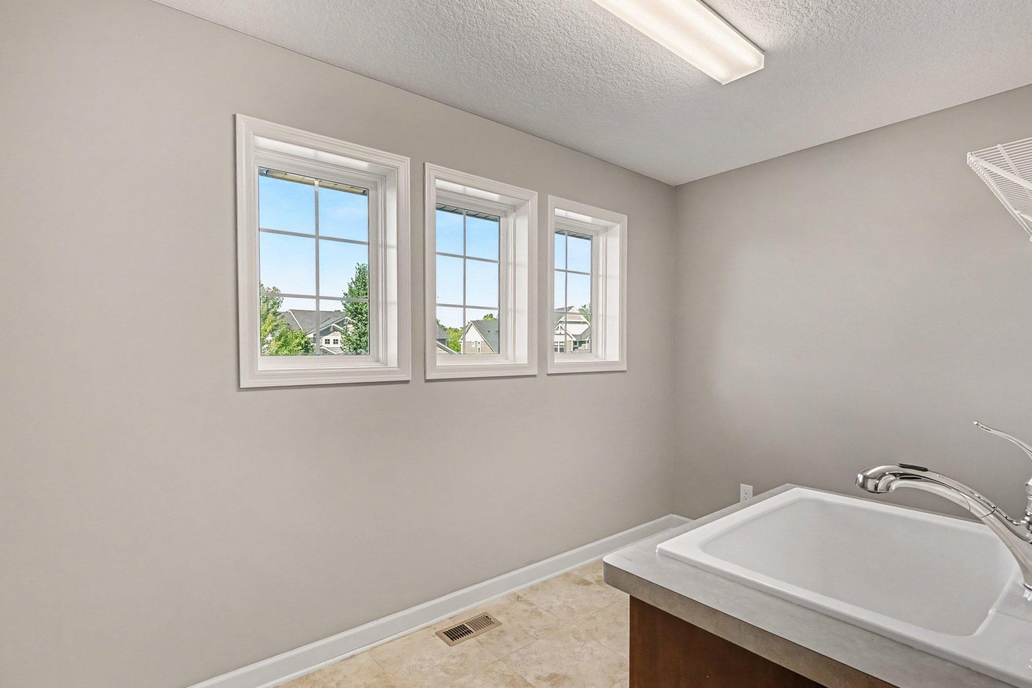 Super convenient upper level laundry flooded with light!