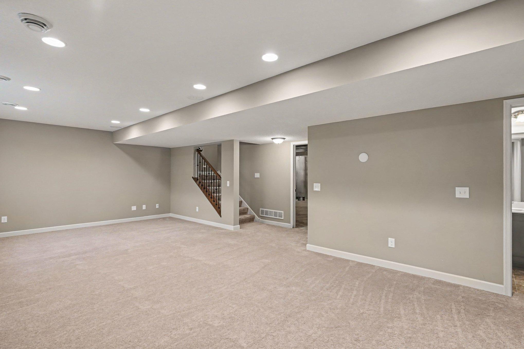 Finished lower level with lots of lighting