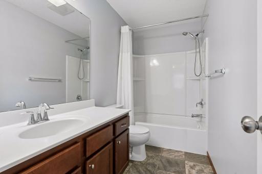 This full bath is spacious and neutral.
