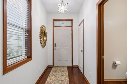 A proper foyer with custom lighting greets your guests.