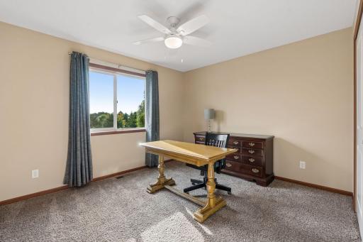 This upper level bedroom is used as an office by the current owners, and has incredible pond views.