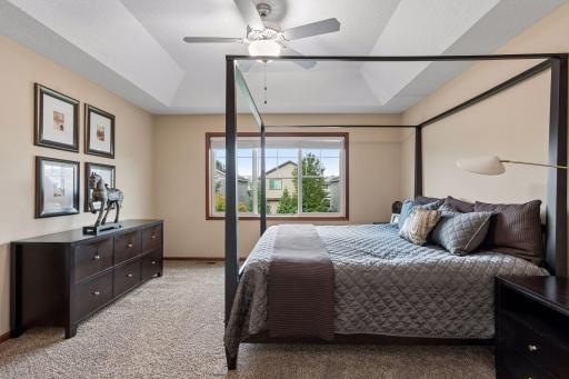 The primary suite is a true retreat, featuring box-vaulted ceilings, a spacious en-suite bathroom, and an extra-deep walk-in closet.