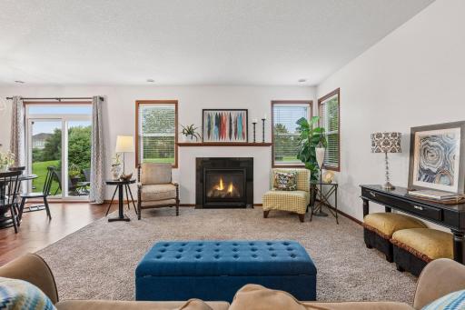 Natural light fills the main level, while the cozy gas fireplace creates a warm focal point.