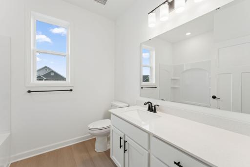 A full-sized bathroom off the foyer is readily accessible to the whole family and daytime guests.
