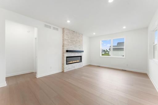 ShawÂ® luxury plank flooring runs throughout the Great Room, kitchen and dining room to create a cohesive look.jpg