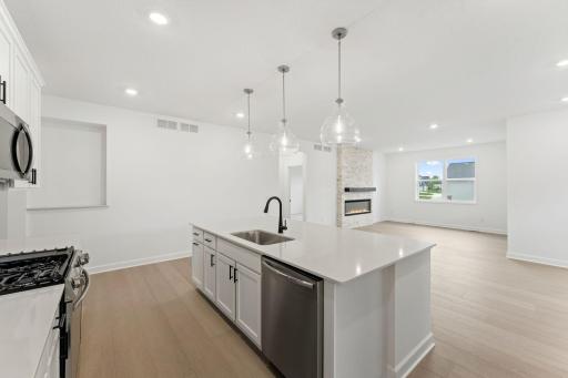 Elegant pendant lights at the center island brighten everyday activities