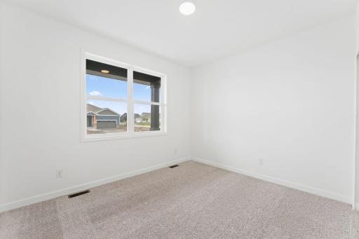 This secondary bedroom provides excellent sleeping accommodations for family members or overnight guests.