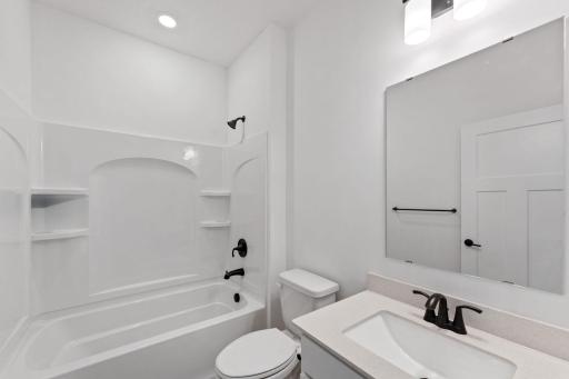Conveniently located alongside the secondary bedroom, this full bathroom features an undermount sink with a MoenÂ® faucet and a combination tub and shower with built-in shelves.