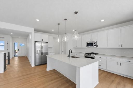 Featuring a brand-new stainless steel appliance package, a large rectangular center island and a pantry, the stylish kitchen is well equipped for cooks of all skill levels.